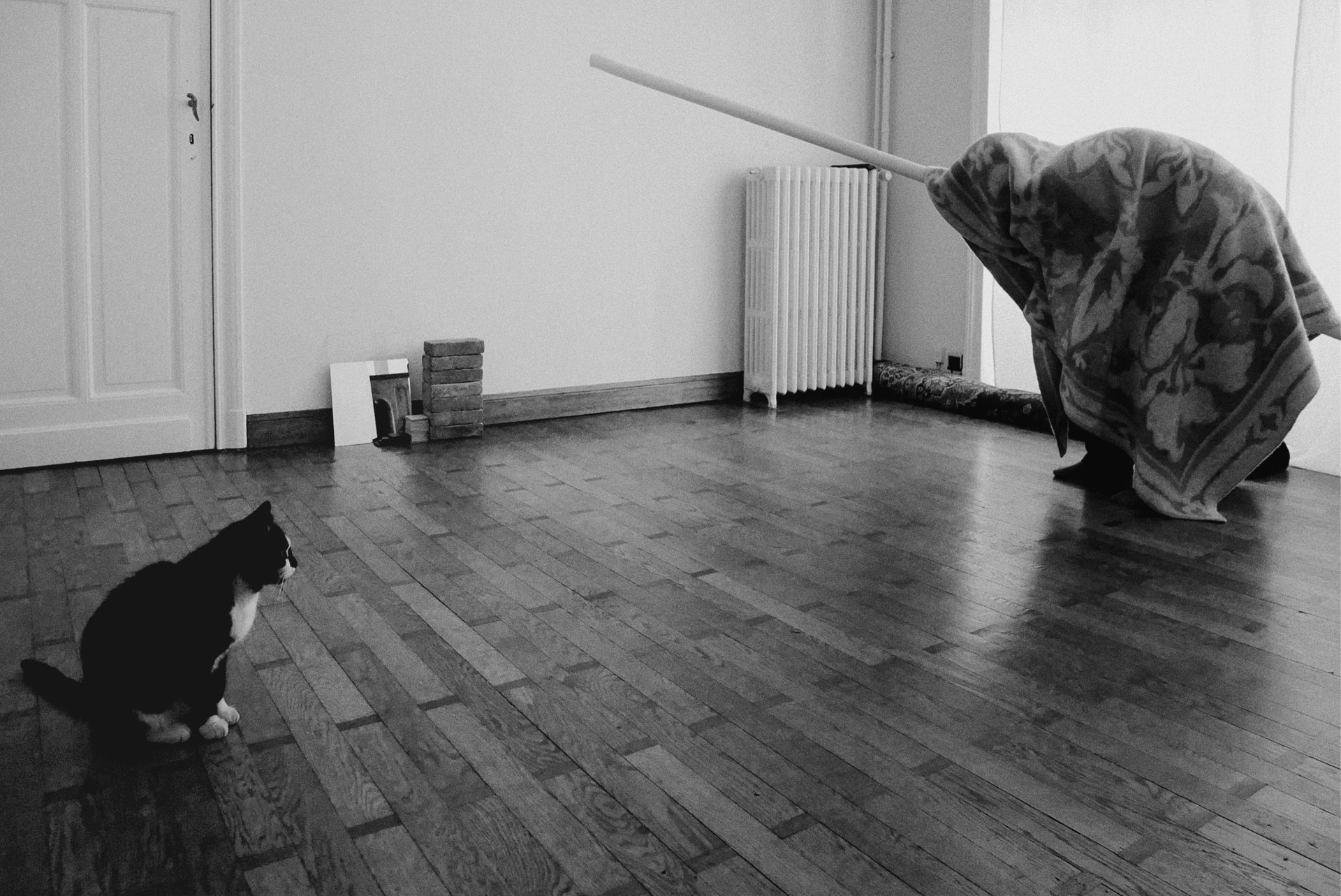 man with cat in empty living room
